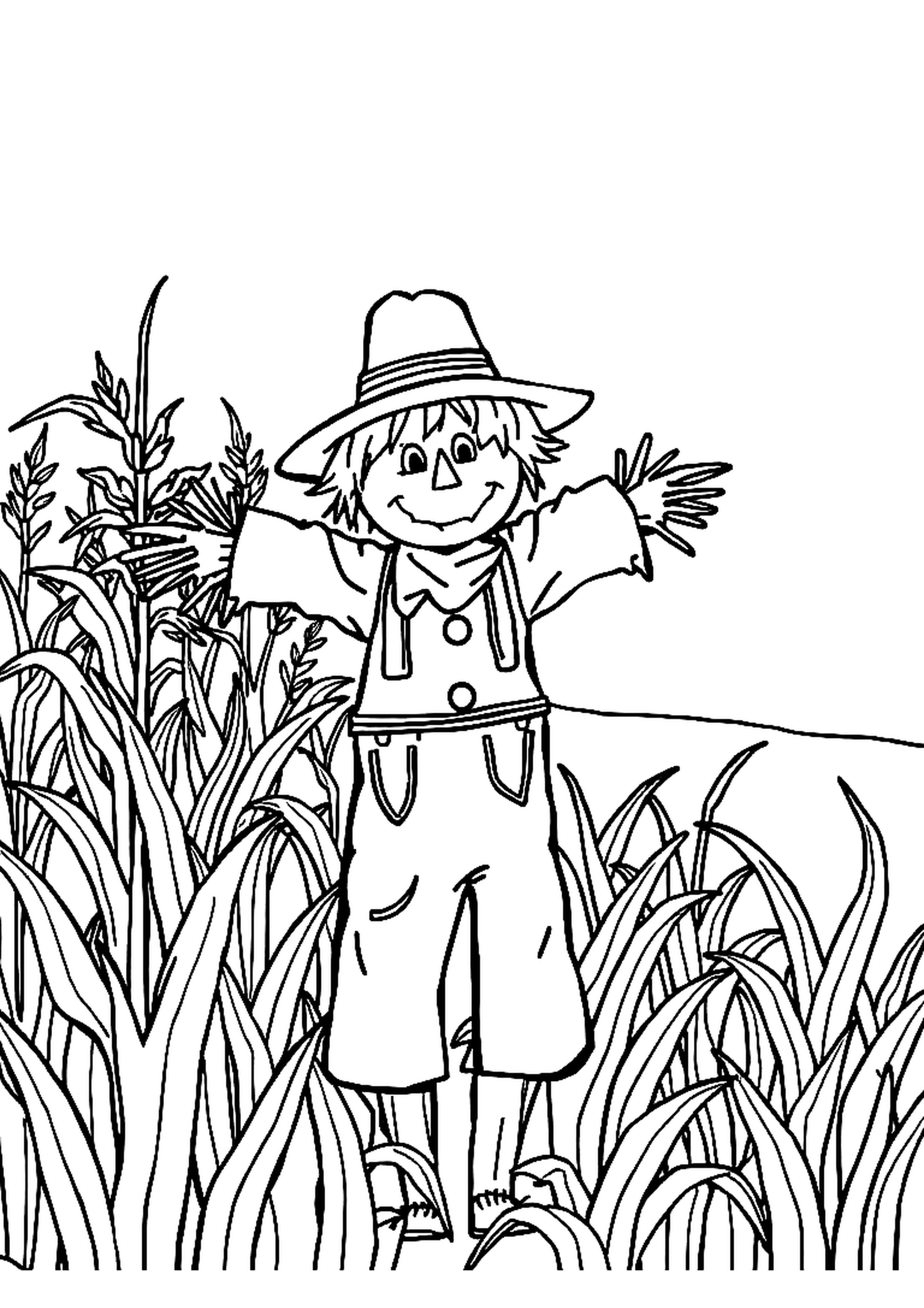 Scarecrow standing in a field of golden corn under autumn sky